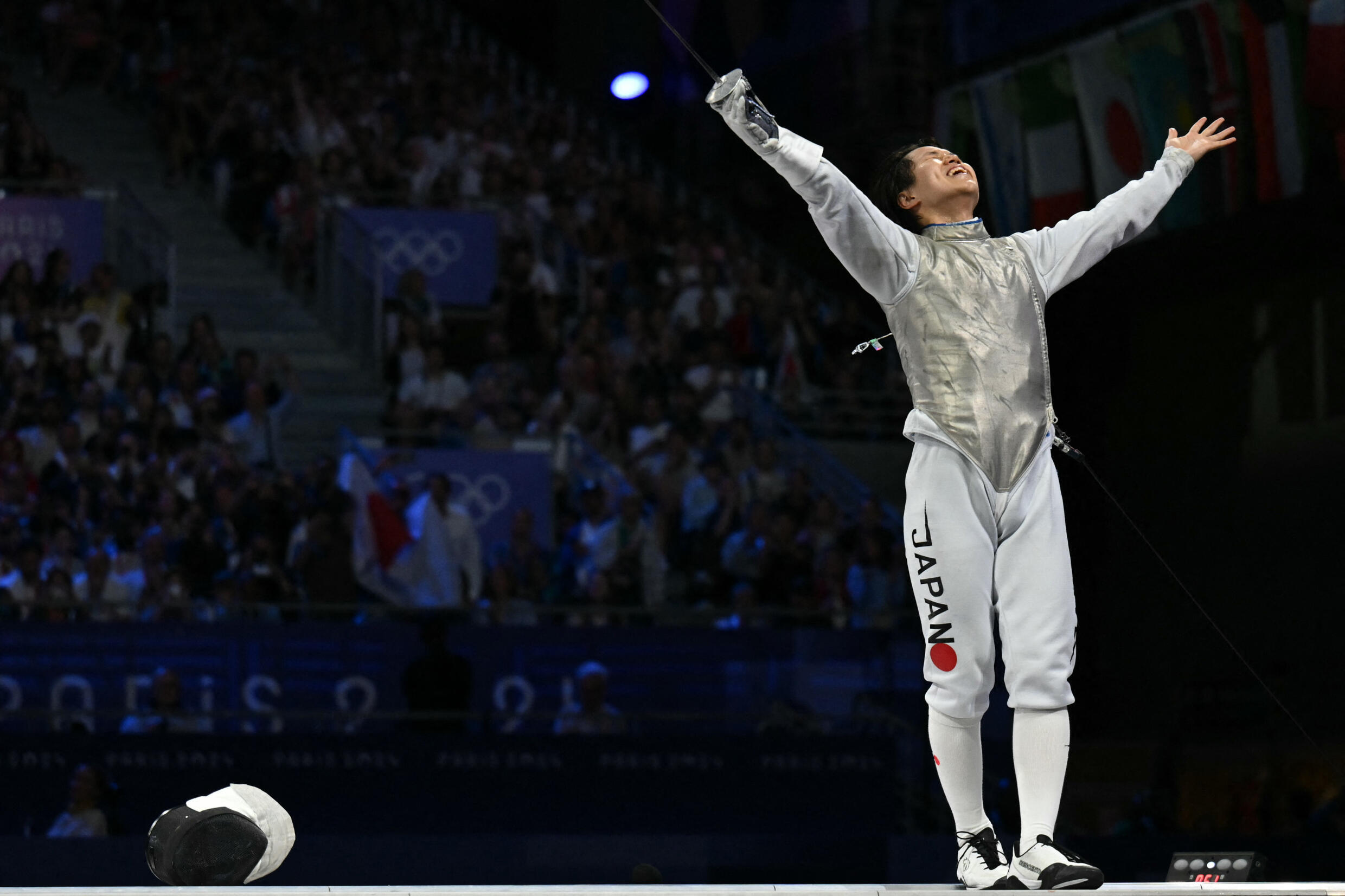 Japan's Kazuki Iimura celebrates after winning in the men's foil team gold medal bout between Japan and Italy during the 2024 Olympic Games at the Grand Palais in Paris on August 4, 2024.